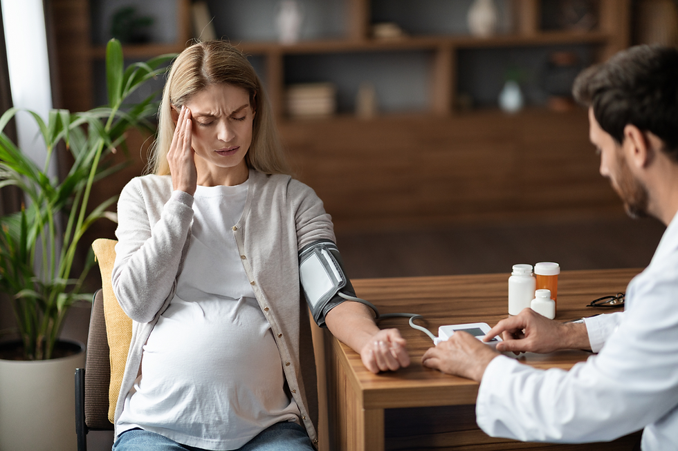 Pregnant patient discussing anti-emetic medication options with doctor to treat Hyperemesis Gravidarum.