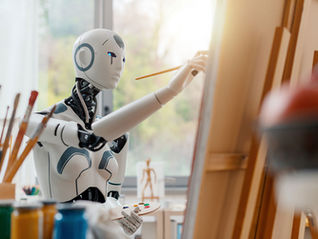 A robot paints at a canvas on an easel
