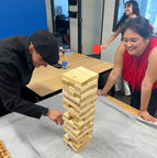 Image of two people playing jenga and one playing ping pong