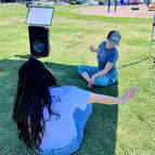 Image of two women on the grass stretching