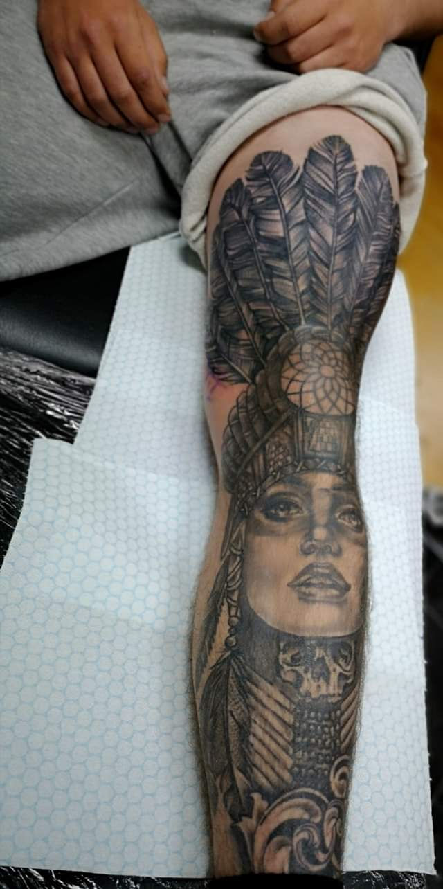 Native American headdress woman portrait tattoo on leg by Abbie Cadaverous at Studio28, angle 1