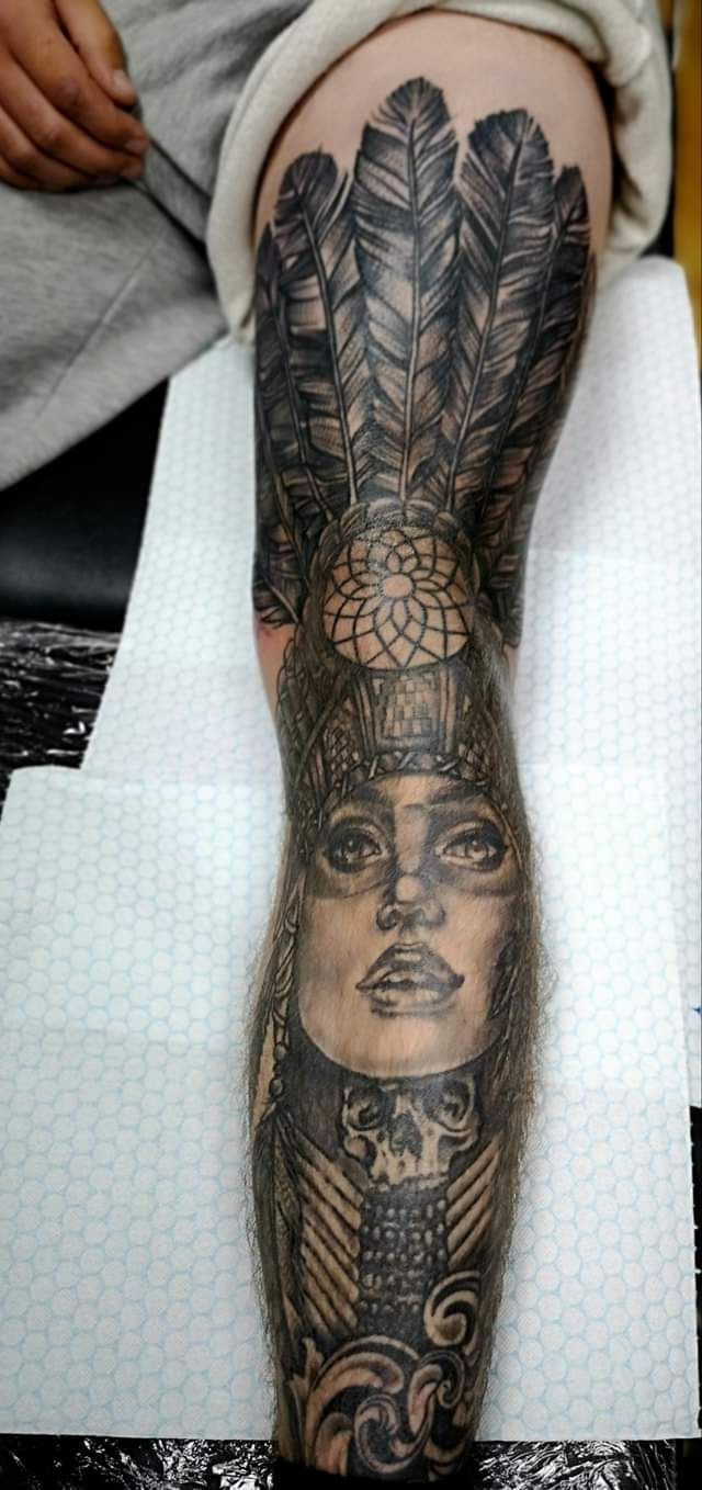 Native American headdress woman portrait tattoo on leg by Abbie Cadaverous at Studio28, angle 2