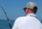 Man fishing, wearing Cablz Flyz orange