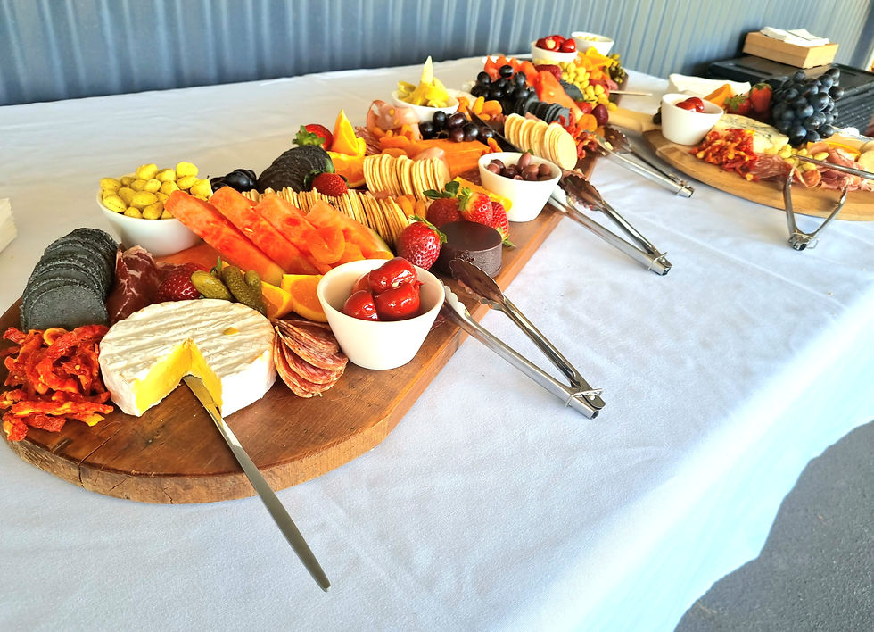 Grazing table with cured meats, cheeses, pickled vegetables, fruit, crackers and crispbreads. The entire spread is gluten-free.