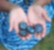 Hands holding painted stones