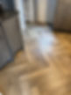 A kitchen featuring warm wood floors and wooden cabinetry, creating a cozy and inviting atmosphere