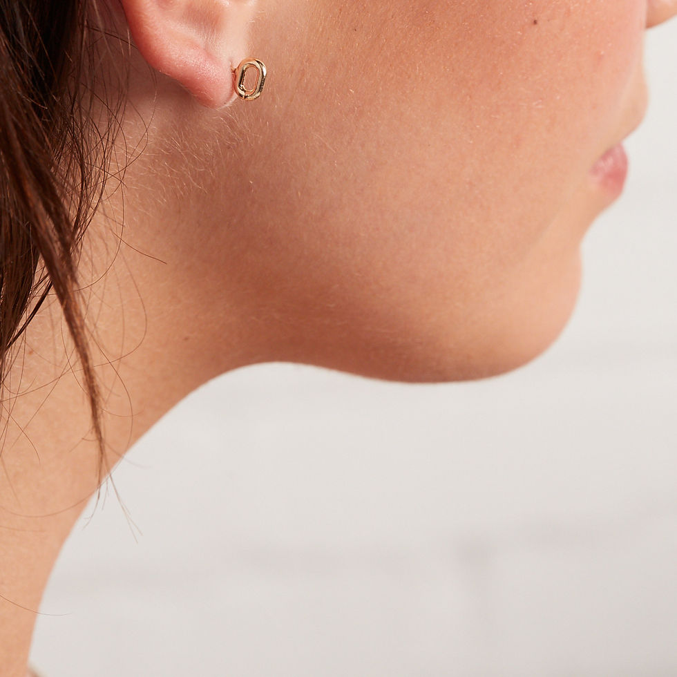 Woman's profile, showcasing delicate gold earrings