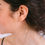 Thumbnail: Woman wearing gold hoop earrings