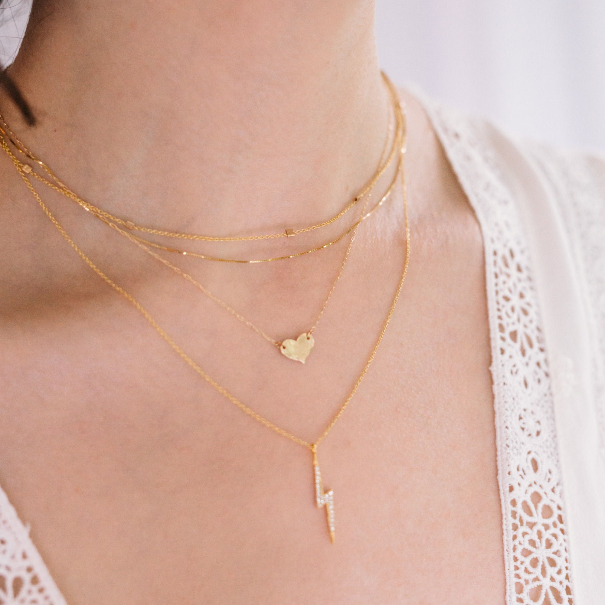 Gold layered necklaces with butterfly and lightning charms