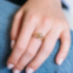Gold ring with small diamond, worn on a hand