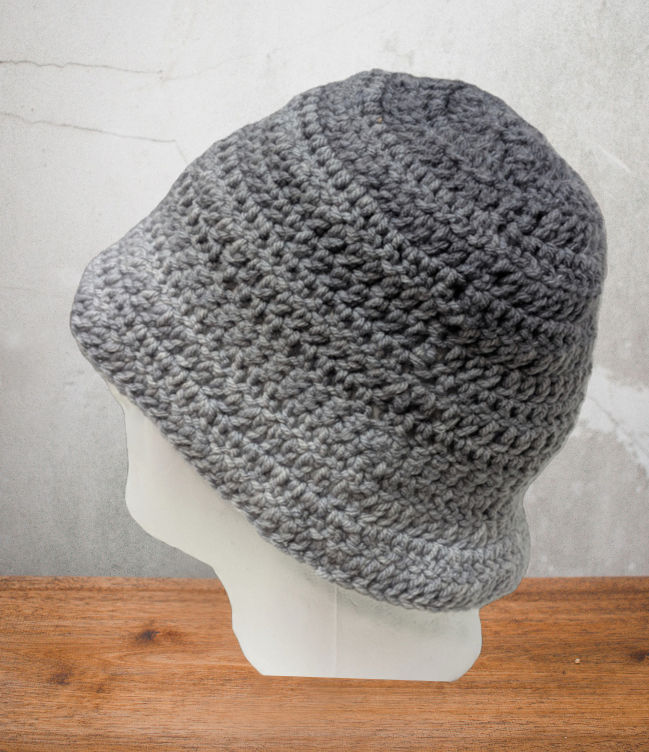 Mannequin head facing backward displaying a handmade crocheted bucket hat with gray and black gradient color...