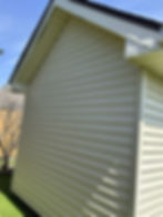 Clean siding showing pressure washing results on a house.