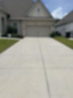 Clean driveway showing pressure washing results.