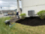 Man spreading mulch, part of a landscaping project in Olathe KS