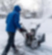 Person snow blowing a driveway