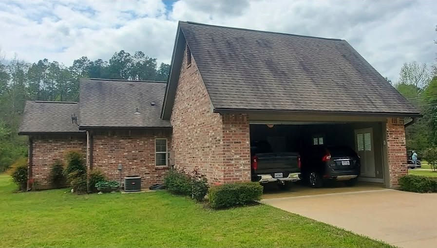 Brick house with two-car garage, vehicles parked inside