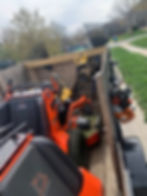 Trailer loaded with mower and trimmers for landscaping projects
