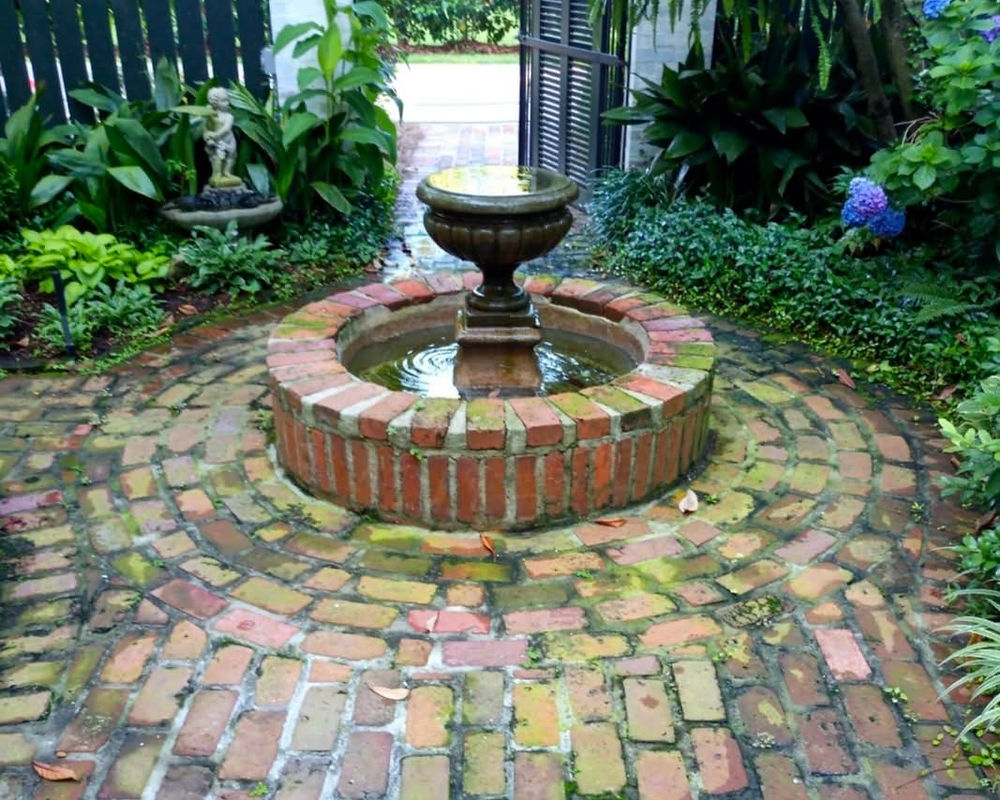Circular brick fountain in a garden