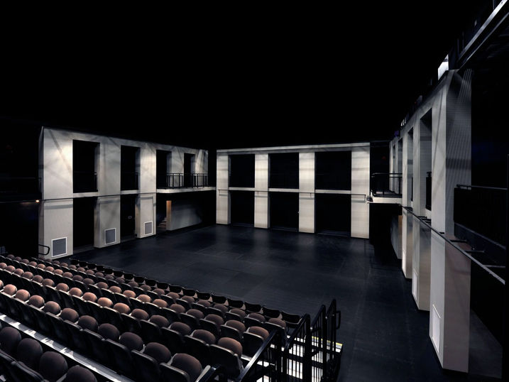 Centrepointe Theatre black box performance space with freshly painted dark stage, seating area, wall panels, upper balcony, and theatrical lighting.