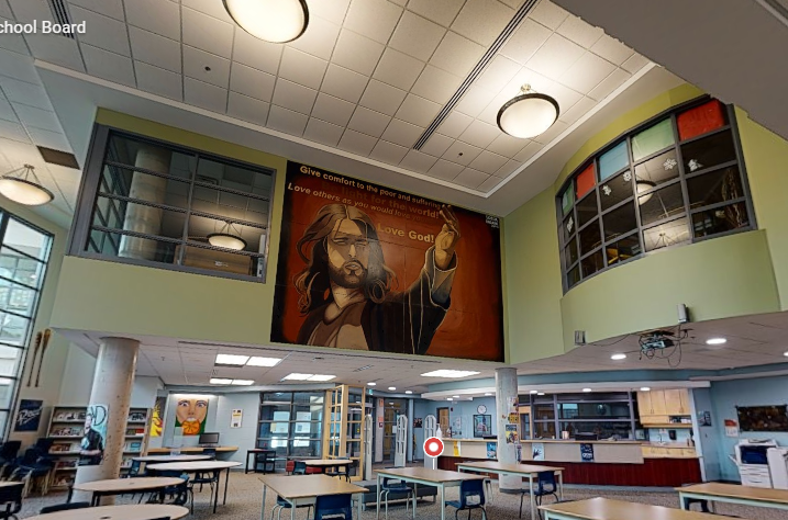 St. Francis Xavier Catholic High School learning commons with freshly painted high walls, tall windows, upper-level interior windows, ceiling details, tables, and bright natural light.