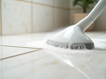 Steam cleaner scrubbing a white tiled floor with soap suds. A potted plant is blurred in the background, creating a fresh, clean mood.