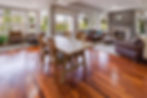 Living room with hardwood floors, area rugs, and furniture representing Stat Carpet Cleaning’s professional cleaning in Louisville, KY