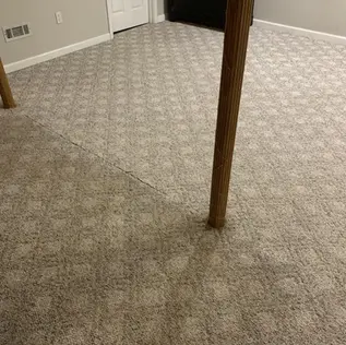 Half-cleaned Berber carpet in Louisville, KY showing clear difference between soiled and freshly cleaned areas.