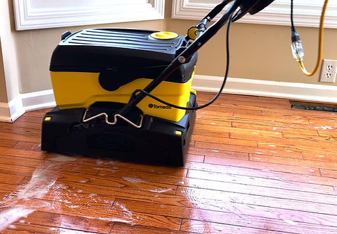 Tornado counter‑rotating brush machine deep‑cleaning hardwood floors during a professional cleaning process in a Louisville home