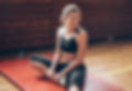 Althetic Woman Stretching On A Gym Mat