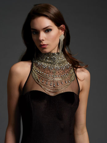 portrait of woman in mock neck cutaway evening gown with crystal beading with diamond earring