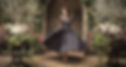 woman in blue gown standing in doorway of lush garden