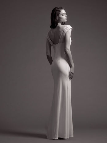 woman in wedding gown looking back over her shoulder