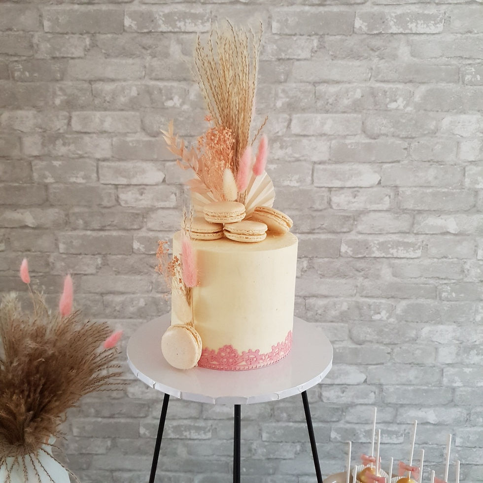 A stylish wedding cake with dried flowers and Italian macarons