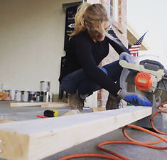 Libby Barnes using a miter saw to cut lumber during the HGTV Saving Spaces renovation