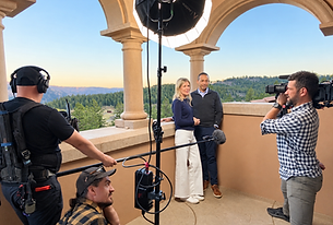 Libby Barnes and her husband, Leon, filming Ranchland Listings on a stone terrace overlooking the Colorado mountains