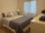 Tidy bedroom showing professional home cleaning results.