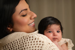 Mother holding baby, studio portrait. Perfect for newborn photography.