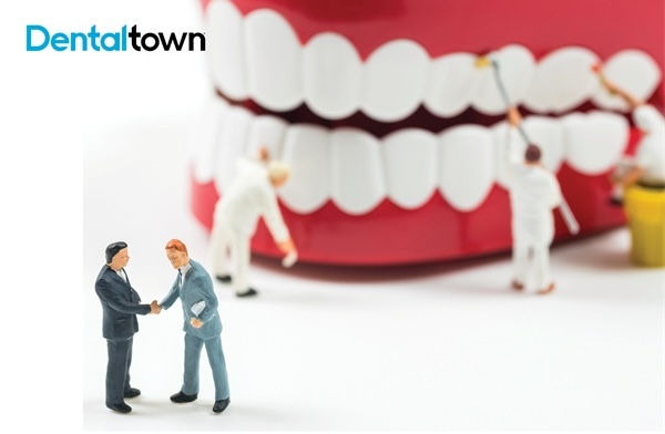 A graphic of a denture with miniature people cleaning it.