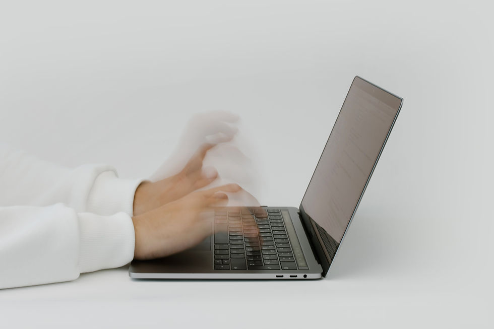 Hands blurred in motion type on a laptop keyboard, suggesting fast typing. The background is plain white, creating a clean look.