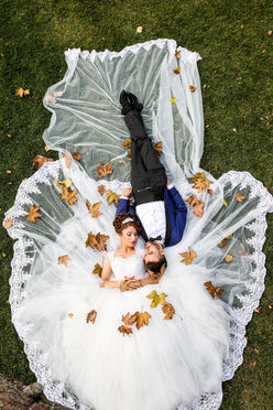 Aerial wedding photography of bride and groom laying on grass – Destination wedding photographers in Dubai