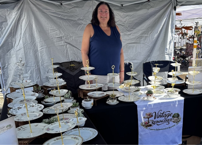 Vintage Reimagined booth at an Arizona craft fair, tables of tiered china cake stands and teacup succulents.