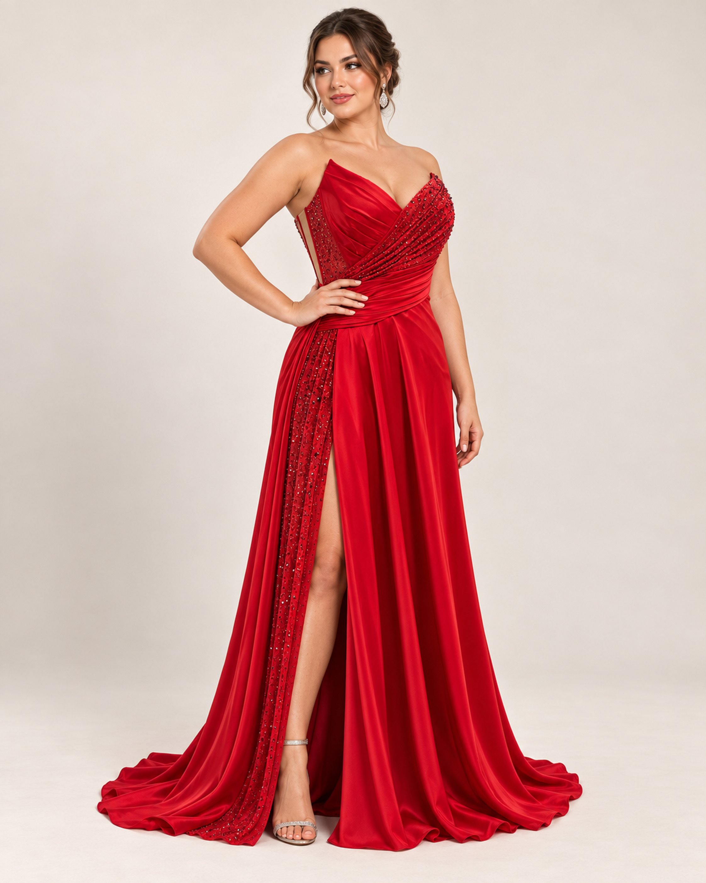 Side view of model wearing Red strapless evening gown with a beaded bodice, sheer corset back, and a high leg slit
