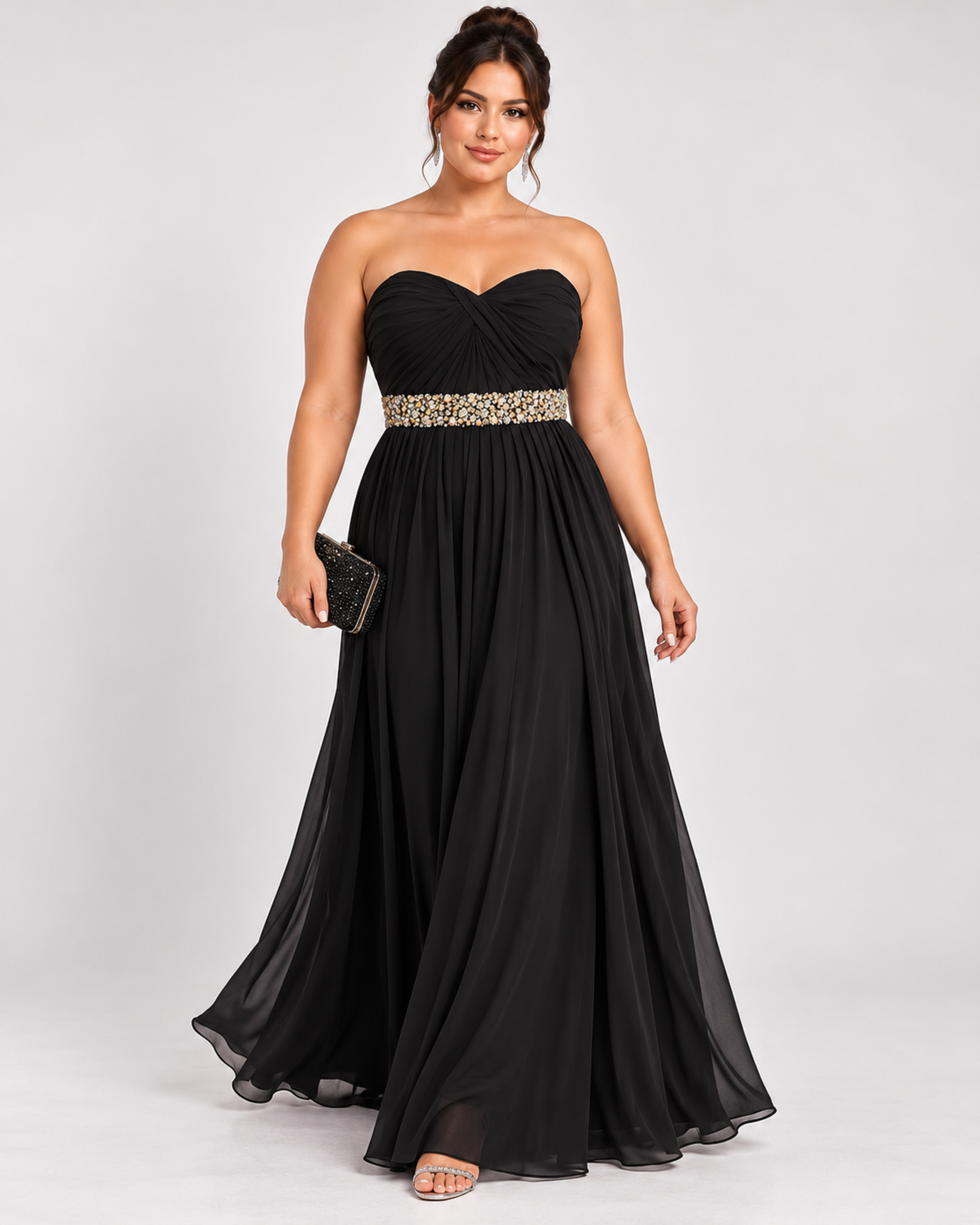 Front view of the model wearing black strapless sweetheart dress ideal for black tie events and formal events