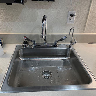 Sink with added faucet