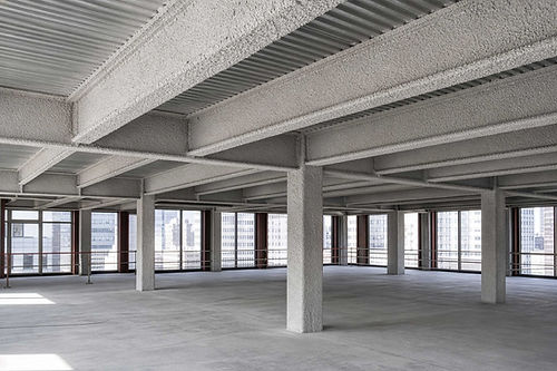Empty industrial office space with concrete pillars.