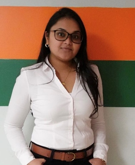 Woman with glasses in a white shirt, Meet the Team