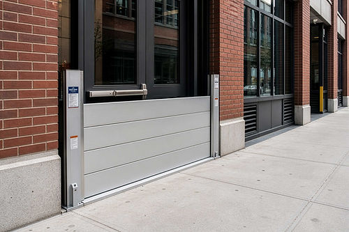 Flood barrier installed across a brick building entrance