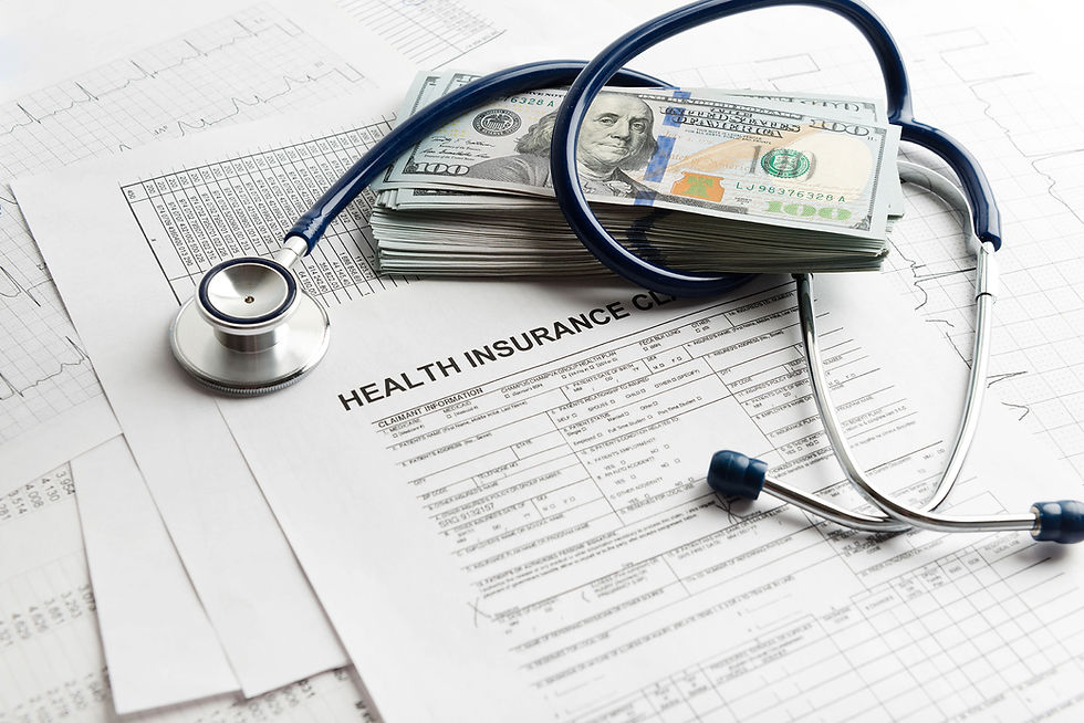 Stethoscope on health insurance forms with a stack of cash. Background includes graphs and a "HEALTH INSURANCE CLAIM."