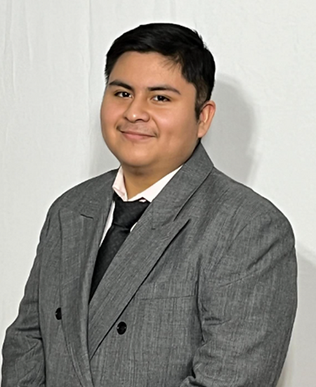 Smiling man in a grey suit and tie for Meet the Team.