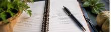 Open journal and pen used to plan and prepare for a spiritual retreat weekend